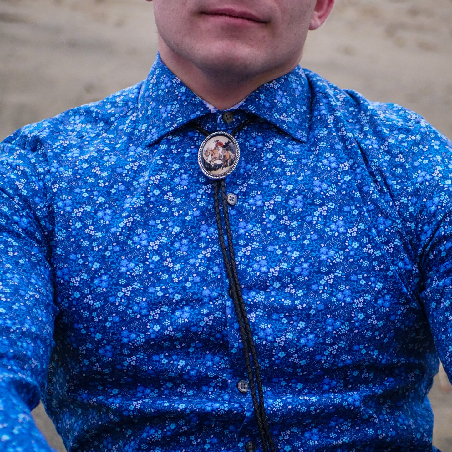 the part of the bolo tie is called a bezel, or slider.