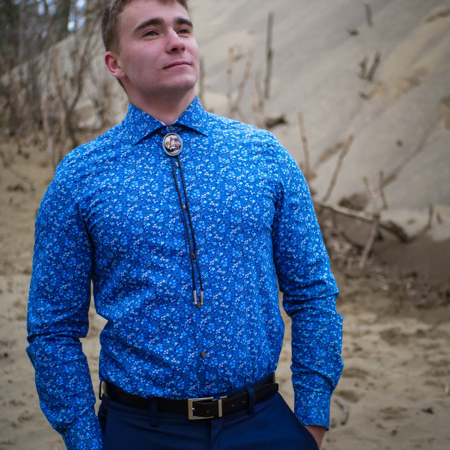Bolo ties symbolize cultural heritage, fashion, and individuality for men. They represent Southwest traditions, personal style, and often feature symbolic motifs like the thunderbird for power and strength.