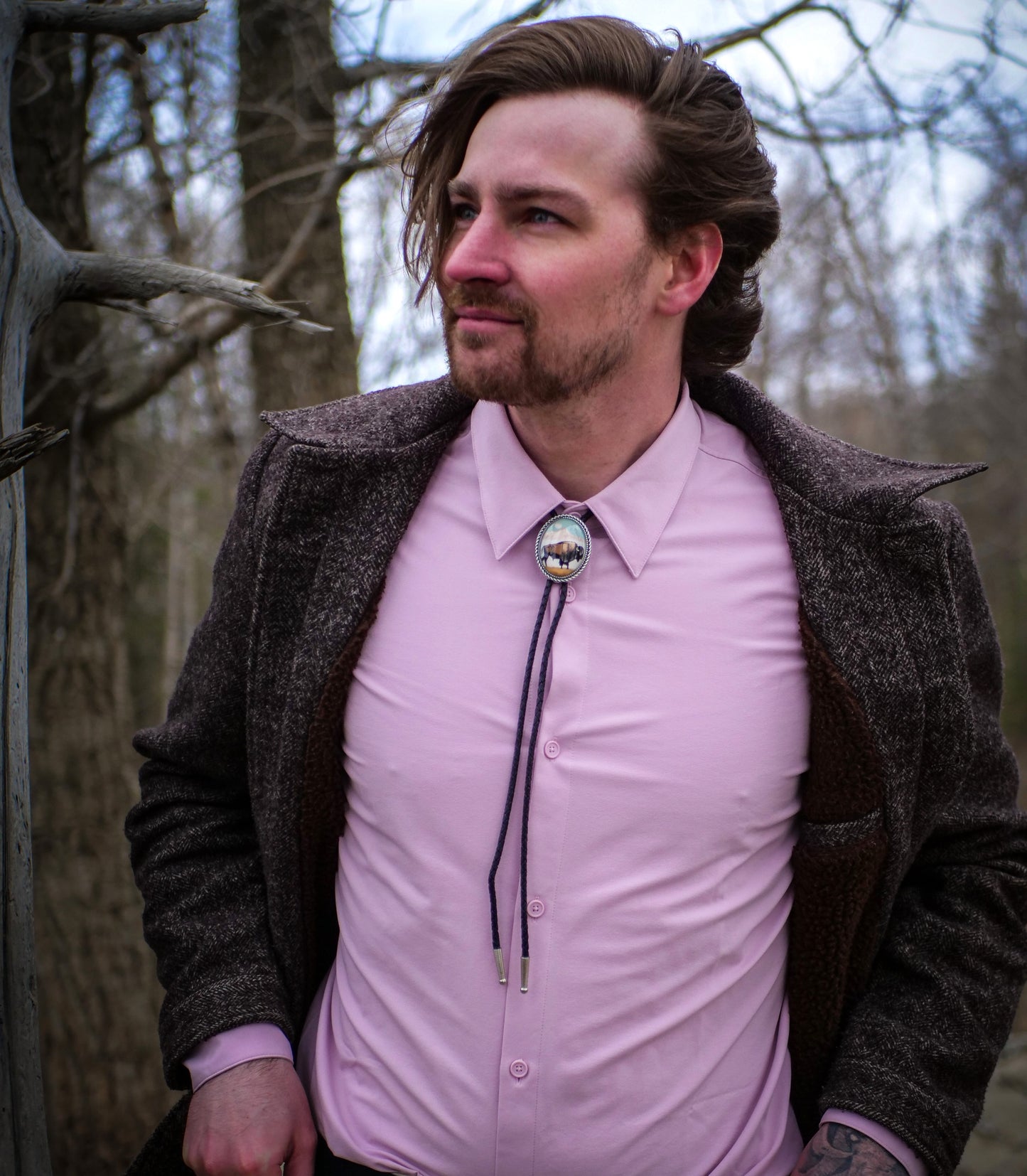 A bolo tie should be long enough to reach a few inches below the breastbone/sternum