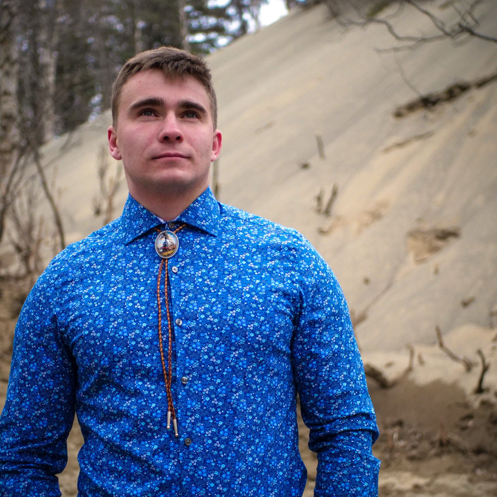 a western wedding with a train bolo  tie on a young man